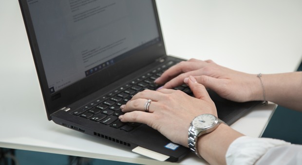 Kvinna skriver på en dator.