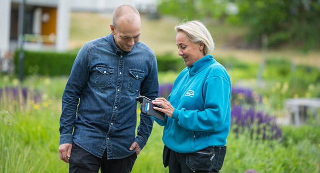 Bovärd visar upp något i sin mobil